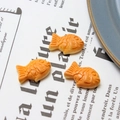Three orange resin Taiyaki miniature fish charms for DIY jewelry and phone case making - Taiyaki