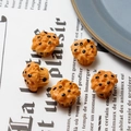 Five miniature resin muffin cake models for DIY crafts featuring orange color and chocolate chips - Cupcake