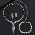 Close-up of sparkling bridal jewelry set with rhinestone fringe necklace and silver bracelet - Snowflake Silver 3-Piece Set