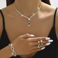 Detail shot of a gold crystal jewelry set with green pear-shaped gemstone pendants - 3-Piece Set (G229+746) / Gold-Green