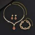 Detail of gold necklace set featuring red pear-shaped gemstones and sparkling rhinestones - 3-Piece Set (G229+746) / Gold-Red