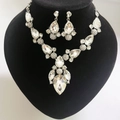 Macro shot of bridal jewelry set with sparkling diamond rhumb pendants on a black bust - Pear Shaped Clear Rhinestone Set (D1 Silver White) / Silver