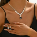 Close-up of luxury V-shaped necklace and drop earrings with black teardrop crystals - Silver Black Water Drop Two-Part Jewelry Collection (501)