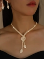Close-up of elegant V-shaped gold necklace and matching crystal drop earrings set - 2-Piece Set (G431) / Gold