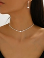 Close-up of model wearing silver crystal choker necklace and matching drop earrings - Silver