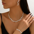 Sparkling wave jewelry set including necklace, bracelet and earrings on female model - Silver