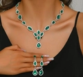 Elegant water drop jewelry set with emerald green stones and silver finish on model - Green