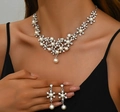 Elegant silver floral jewelry set with white pearls and sparkling crystals on a model - Silver
