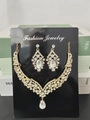 Sparkling water drop rhinestone necklace and earring jewelry set in golden finish - Gold White