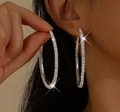 Close-up of a large silver hoop earring with sparkling rhinestones on a female model - Silver Hoop Earrings