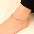 Detail of a gold beaded snake chain anklet on ankle with smooth polished metal texture - Round Bead Anklet (Gold) 22+5