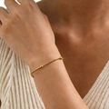 Minimalist gold bangle with bead accents worn on wrist with cream knit sweater - Round Bead Bracelet (Gold) 16+5