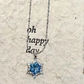 Elegant snowflake pendant necklace with blue crystal and silver chain on textured background - Blue