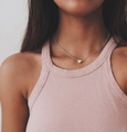 Close-up of a minimalist silver heart pendant necklace worn on the collarbone - Silver