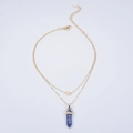 Detail of layered gold necklace with heart pendant and blue hexagonal crystal column - Blue Spot Jasper