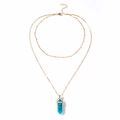 Detail of double-layered gold chain with turquoise hexagonal prism crystal pendant - Turquoise
