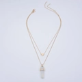 Detail of layered gold necklace featuring a heart pendant and hexagonal stone column - Opal