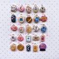 Macro view of 25 unique 18K gold plated stainless steel enamel pendant charms in a grid - Crystal Ball Style (No.25)