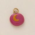 Detail of pink ceramic moon pendant with 18K gold plated metal ring on white background - Pink Moon Style
