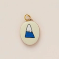 Detail of 18K gold-plated oval pendant featuring a minimalist mountain landscape design - No.7 Oval Snowy Peak