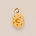 Macro detail of oval celestial pendant with 3D moon and star patterns in gold plating - No 13 Oval Star Moon