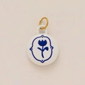 Detail of round white pendant with blue tulip motif and 18K gold plated hanging ring - No 16 Oval Blue Rose