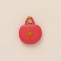 Detailed close-up of pink round pendant featuring a golden starburst motif and gold hoop - Pink Starburst Style