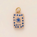 Detail of handmade sun pendant with blue sun graphics and gold-plated ring connector - No 18 Square Blue Starburst
