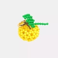 Close-up of creative apple-shaped ring crafted from yellow beads on a gold metal band - Lemon