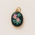 Detail of vintage 18K gold plated oval pendant with pink floral pattern on black enamel - Black Base Pink Floral Oval Style