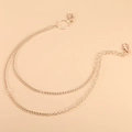 Close-up of dual-layer golden metal waist chain with lobster clasps and polished finish - Layered Chain Style / Gold