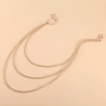 Detailed view of triple-layered golden metal pant chains with lobster clasps for punk style - Multiple Layer Style / Gold