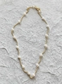 Elegant gold chain necklace with evenly spaced white pearls on textured grey stone - 40CM / Light gold