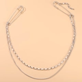 Silver multi-layer chain accessory with safety pin buckles on a plain orange background - Double Layer Chain Safety Pin / Silver