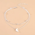 Detailed macro view of silver double-layer anklet featuring moon pendant and metal beads - Silver