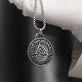 Macro view of Viking Valknut pendant with Rune engravings on a vintage box chain - Silver Tone Pendant And Silver Tone Chain