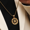 Macro shot of gold Valknut and Vegvisir Norse runes engraved on a round pendant necklace - Gold