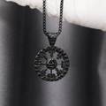 Macro detail of a black Viking Valknut pendant with Nordic runes held in white gloves - Black