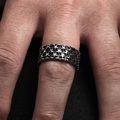 Close-up of vintage wide stainless steel ring with embossed stars on hand - US 7 / Steel