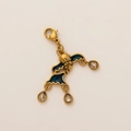 Macro detail of a 18K gold-plated heart pendant with blue enamel and crystal drops - Gold Whale Pendant
