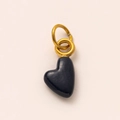 Close-up of heart-shaped black enamel pendant with gold-plated rings for DIY necklaces - September Heart Pendant / Black