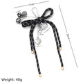 Detailed view of DIY bag charm with black and white bow, dice, and metal heart pendants - Dice Heart Rose Style / Black