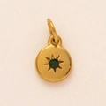 Detail of a gold circular birthstone pendant with a green gem and starburst engraving - May Birthstone Pendant