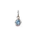 Detailed view of handmade irregular 18K silver pendant with round sky blue gemstone - March