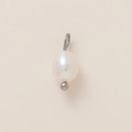 Close-up of a natural oval freshwater pearl pendant with a 18K gold plated steel ring - Pearl Pendant