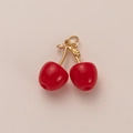 Detailed view of red cherry pendants with gold stems and rings for DIY jewelry making - Cherry