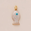 Detailed macro of gold fish pendant with white enamel inlay and turquoise eye - White Fish