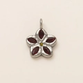 Macro detail of a 18K gold flower pendant with five red petals and a yellow core gem - Lucky Clover Pendant