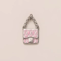 Detailed view of silver handbag pendant with pink enamel and quilted texture - Bag Pendant