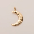 Close-up of a gold-plated crescent moon pendant featuring a unique hammered metal texture - Moon Pendant